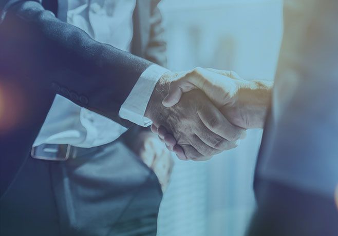 A close-up of two hands shaking.